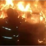 Bomberos trabajan en el control de un incendio de gran magnitud en un predio vehicular.