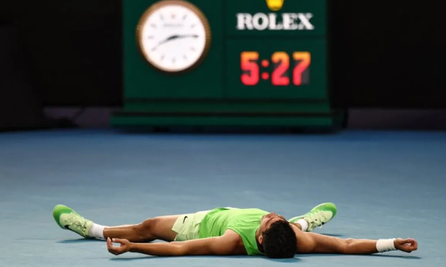 Carlos Alcaraz permanece tendido en el piso, visiblemente exhausto, luego de una batalla de más de cinco horas que lo depositó en la final del Abierto de Australia.
