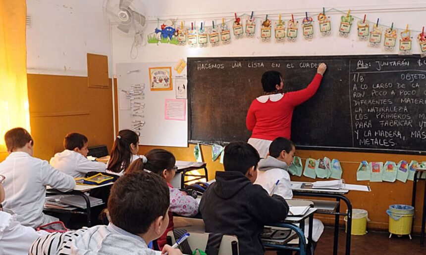 Docente dictando clases frente a sus alumnos en un aula de escuela pública. Foto de archivo.