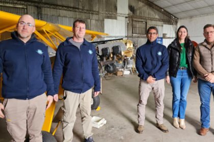 Rodrigo Borla junto a integrantes del Aero Club de Gobernador Crespo, durante la entrega de un aporte para la restauración de la aeronave de la institución.